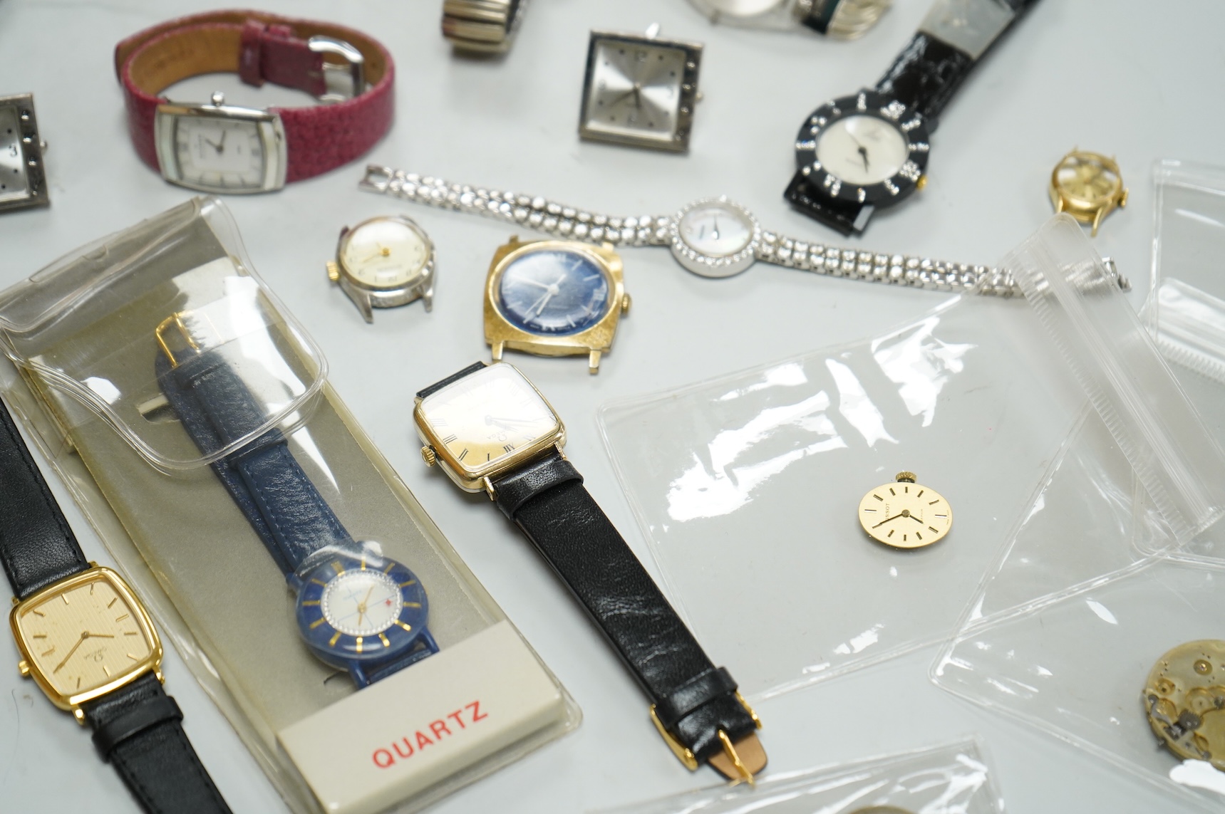 A small collection of assorted lady's and gentleman's wrist watches, including three Omega De Ville steel and gold plated quartz watches and wrist watches movements including Girard Perregaux.